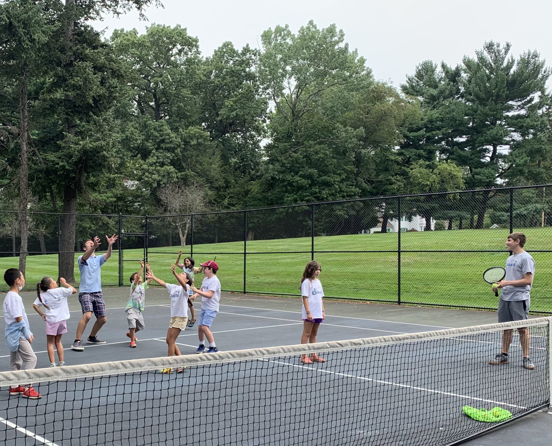 Campers playing on tennis court