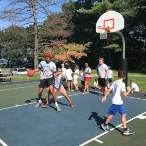campers playing basketball with counselors