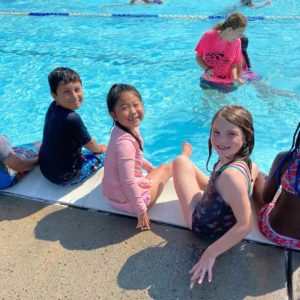 children smiling at swimming pool